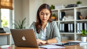 Professional woman sitting at desk reviewing mental health resources on laptop, natural lighting from window, calm organized office environment, thoughtful expression